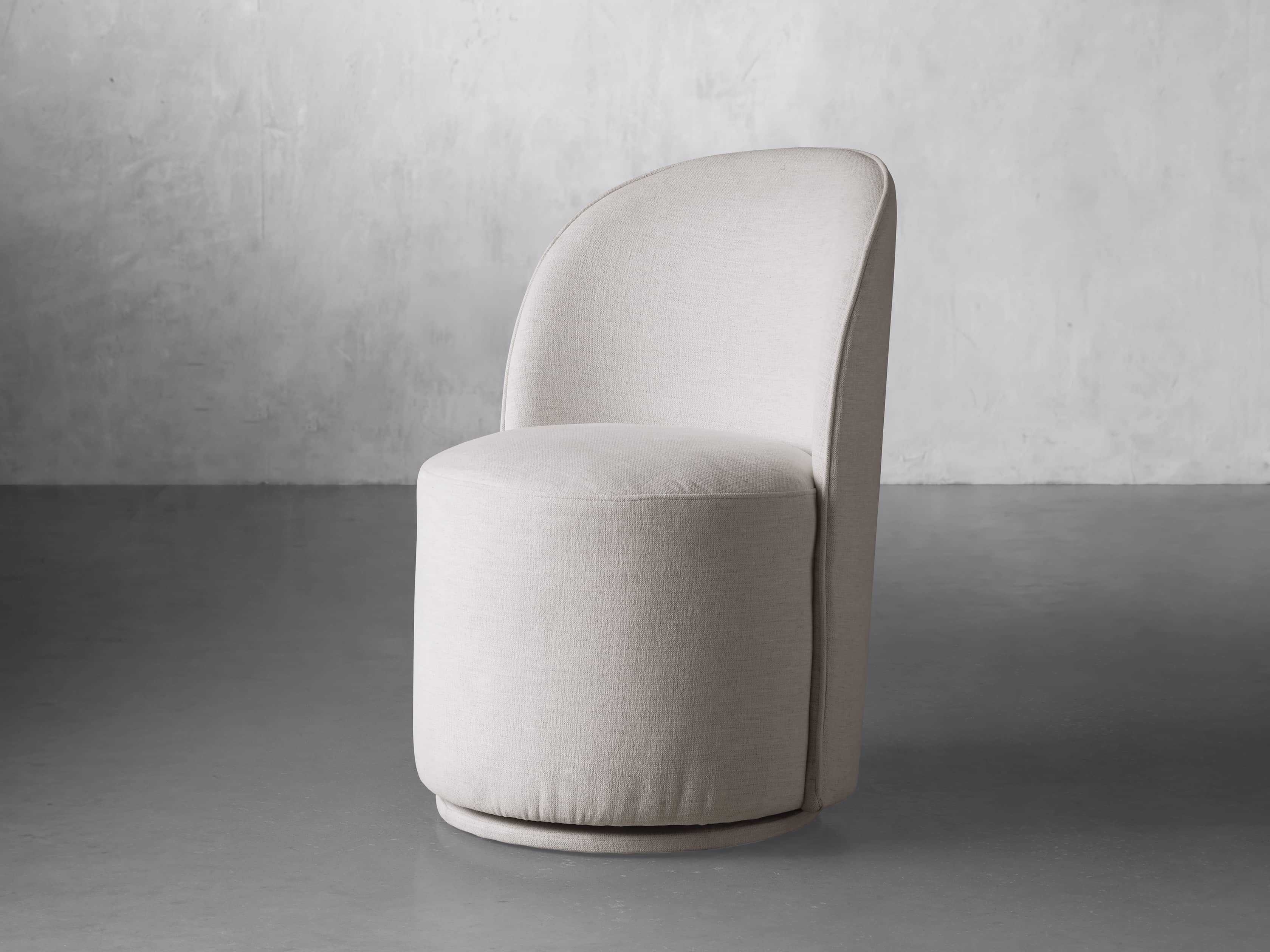 Kira Swivel Dining Chair in Nomad Snow Upholstered White - Image 0