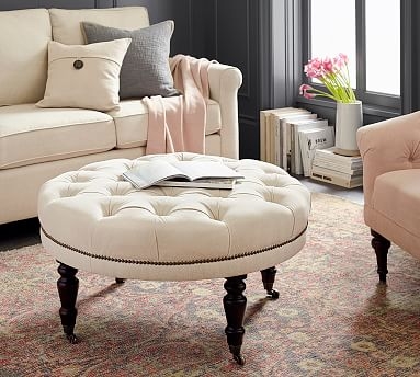 Raleigh Upholstered Round Ottoman with Turned Mahogany Legs " Bronze Nailheads, Twill Cream - Image 0