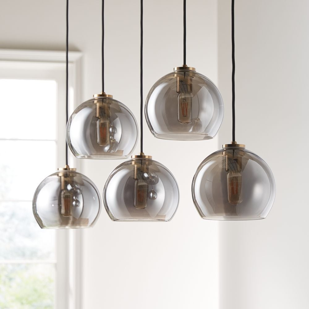 Arren Brass 5-Light Linear Pendant with Round Silver Glass Shades 42" - Image 1