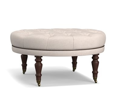 Raleigh Upholstered Round Ottoman with Turned Mahogany Legs " Bronze Nailheads, Twill Cream - Image 1