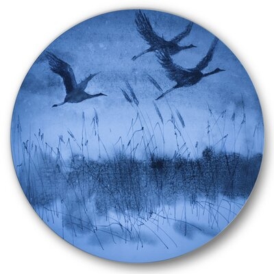 Cranes In Flight During Dark Blue Evening Light - Traditional Metal Circle Wall Art - Image 0