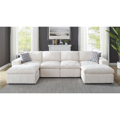 Durah 134" Wide Reversible Modular Sectional with Ottoman - Image 0
